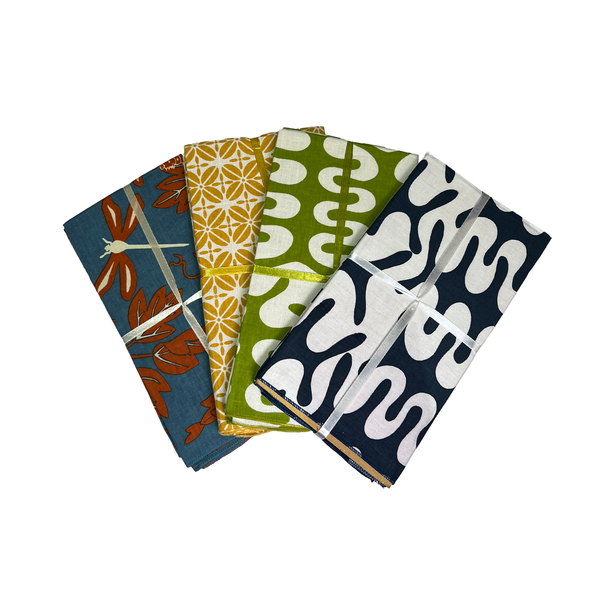 Four napkin sets with different patterns on a white background