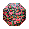Floral-patterned umbrella with pink, red, and green flowers on a black background
