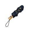 Black umbrella with gold patterns and a wooden handle on a white background