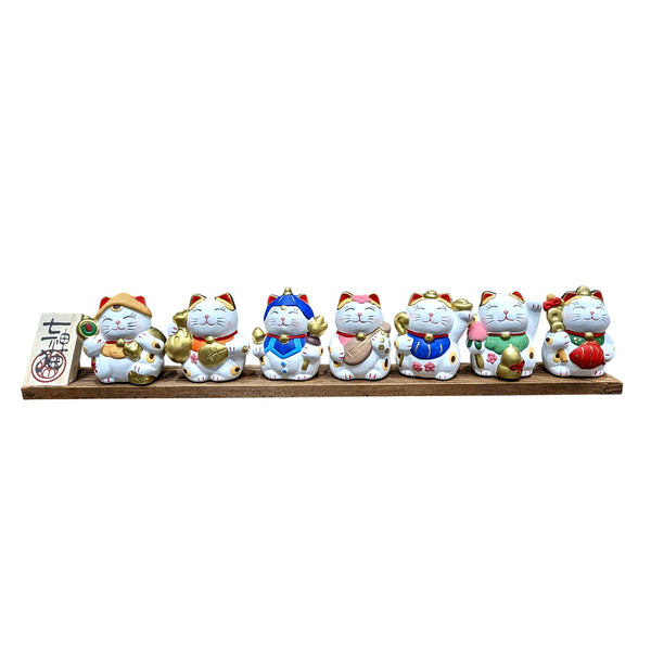 Seven Blessings Lucky Cat Figurines on Wooden Stand