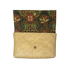 Clutch bag with woven straw design and patterned top section on a white background