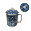 Blue and white ceramic mug with lid on a white background