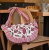 Pink and white bag hanging on back of chair in cafe setting