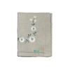 Folded flax tablecloth with floral embroidery on a white background