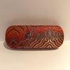 Wave Brocade Eyeglass Case Red propped up
