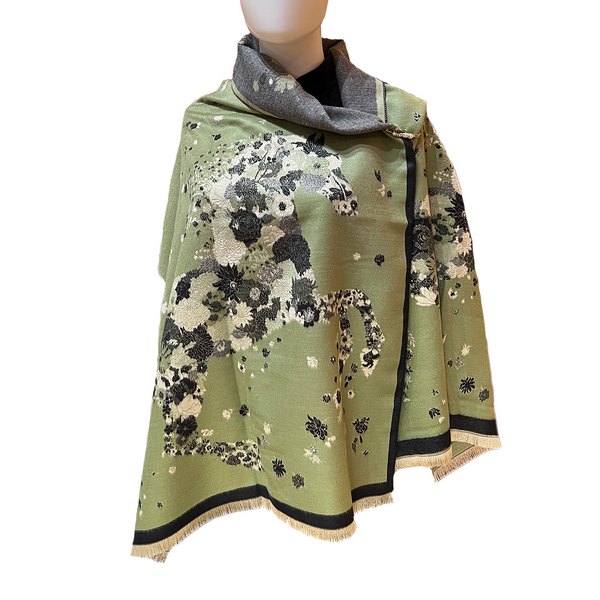 Green floral patterned scarf on a mannequin with a white background