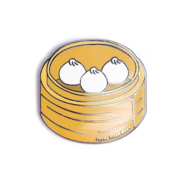 Delicious enamel pin of three little juicy buns in a bamboo steamer
