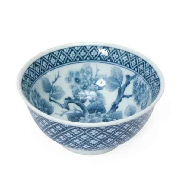 Blue and white ceramic bowl with intricate patterns on a white background