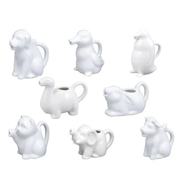 Set of white ceramic animal-shaped pitchers on a white background