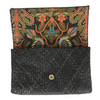 Embroidered fabric pouch with floral patterns on a textured black background