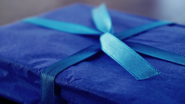 Gift wrapped in blue paper and ribbon