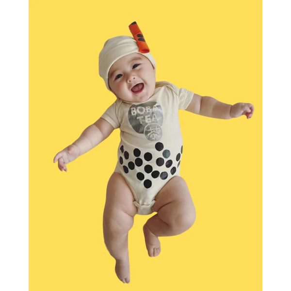 Laughing baby wearing milk boba tea onesie.