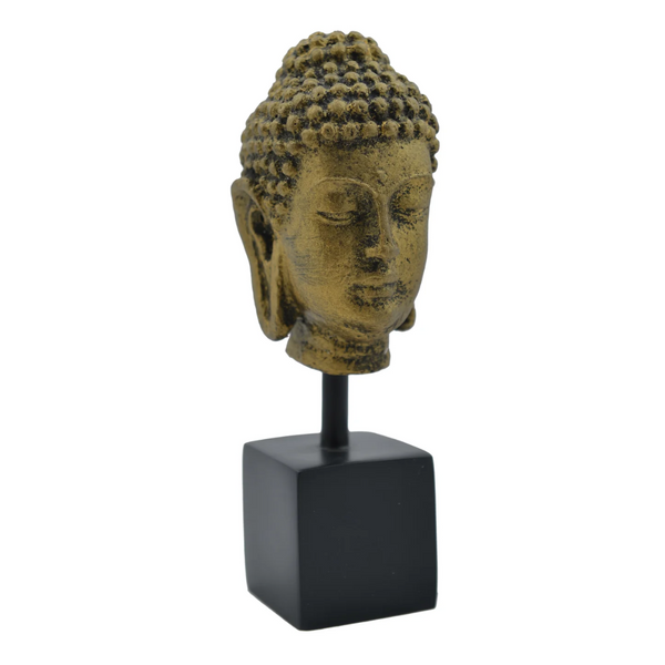 Resin Buddha head sculpture on a black square base against a white background