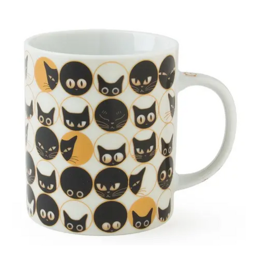 White mug with black and gold cat pattern on a white background