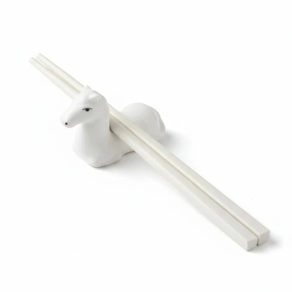 Horse-shaped white holder with chopsticks on a white background