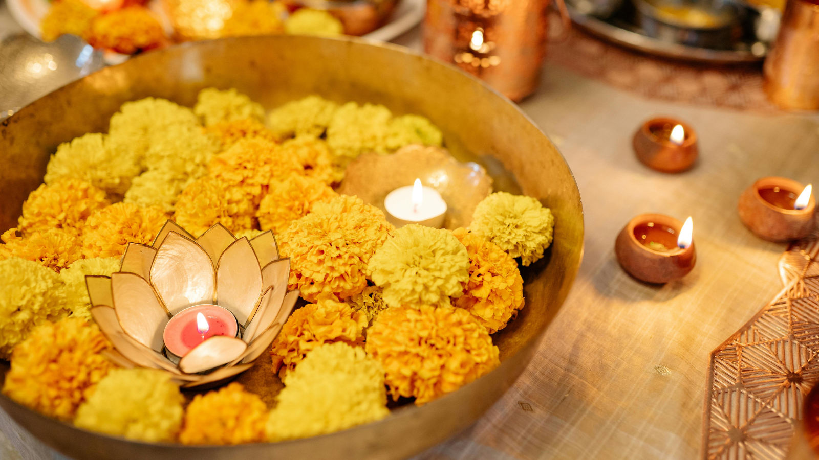 Bowl of yellow flowers and floating candles
