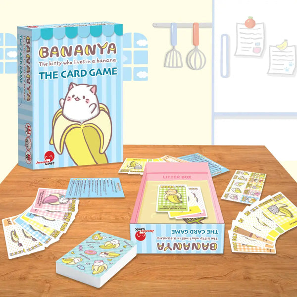 The Bananya card game box next to its game, all set up
