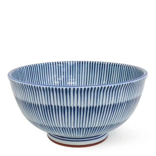 A ceramic bowl with a blue and white striped pattern, featuring vertical ridges on the exterior and a small brown foot ring at the base, set against a plain white background.