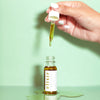 Honey Belle Elixir Facial Oil handing dropping oil