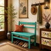 Nestled entryway with a blue bench, shoes, a hat, and decorative items.