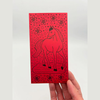 Red envelope with horse design held by a hand on a white background