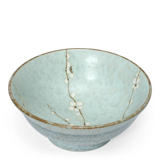 A ceramic bowl with a light blue-green glaze, decorated with delicate hand-painted cherry blossom branches and white flowers, set against a plain white background.