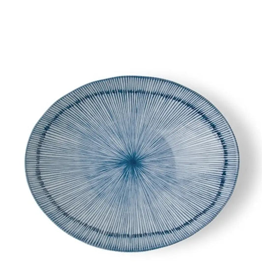 An oval ceramic plate with a blue and white sunburst pattern, shown from a top-down perspective on a white background.