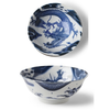 Blue and white ceramic bowl with dragon design on a white background