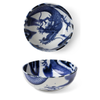 Blue and white ceramic bowl with dragon design on a white background