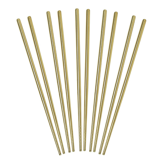 Set of gold metal chopsticks on a white background