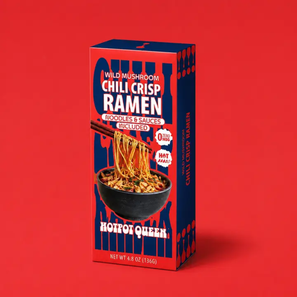 A box of Hotpot Queen Wild Mushroom Chili Crisp Ramen noodles and sauces, shown standing upright on a solid red background. The packaging is dark blue with bold white and red text, featuring an illustration of a bowl of spicy ramen with chopsticks.