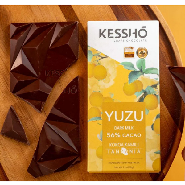 Kesshô Yuzu dark milk chocolate bar on a wooden surface