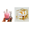 Two keychains: one shaped like a boba  drink with a straw and the other featuring a cat character in a transparent cube.