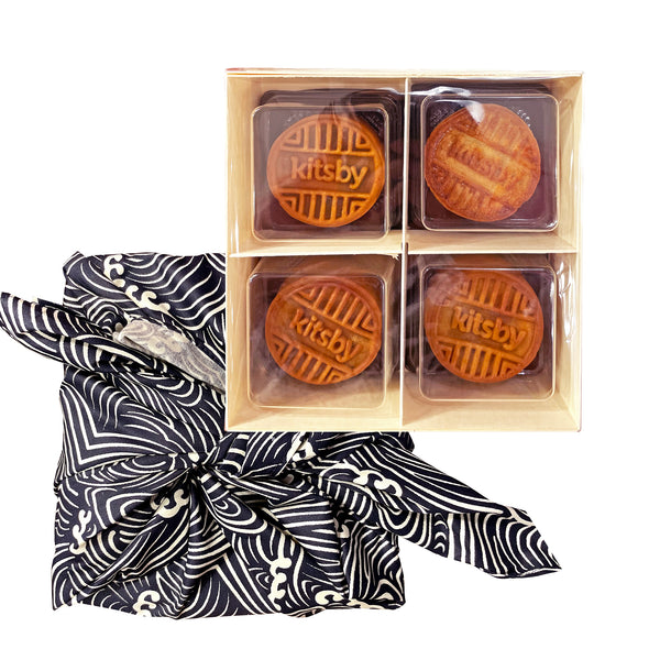 Four mooncakes in box with blue and white cloth