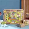 Decorative gift box with colorful design featuring rabbits and traditional Mid-Autumn elements on a blue surface.