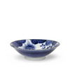 Blue and white ceramic bowl with floral design on a white background