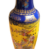 Decorative vase with blue and yellow design on a wooden surface