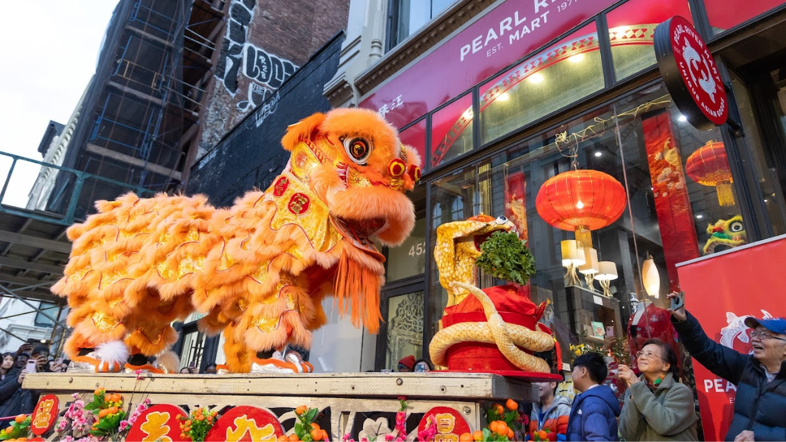 Iion dancers on a platform outside of Pearl River Mart