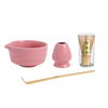Pink ceramic tea set with a glass container labeled 'Matcha' on a white background