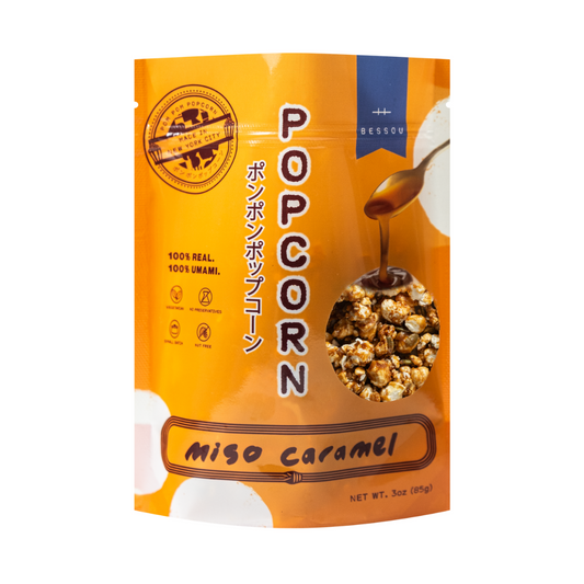 Packaged popcorn with Miso Caramel flavor on an orange background