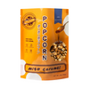Packaged popcorn with Miso Caramel flavor on an orange background
