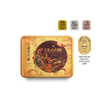 A rectangular metal tin of white lotus mooncakes with a gold and orange illustrated lid, shown on a white background with three small chocolate pieces and an award badge to the upper right.
