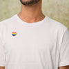 Male wearing a white t-shirt with the Rainbow Silicone Heart Pin attached