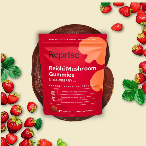 Bag of Reprise Reishi Mushroom Gummies surrounded by strawberries