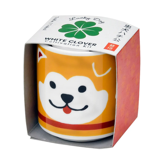Ceramic planter with dog design in a branded packaging box on a white background