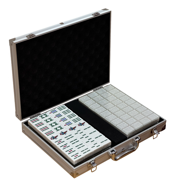 Open Mahjong set in a silver aluminum carrying case with black foam lining, showing the tile rack and game boards on a plain white background.