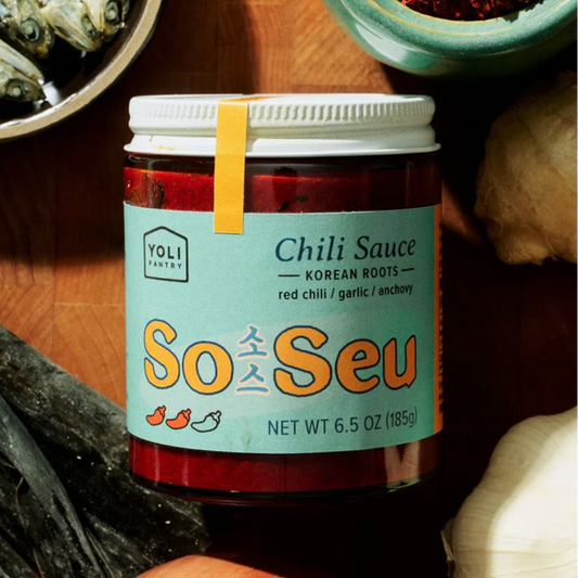 Jar of So Seu chili sauce with a label on a wooden surface