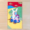 Colorful card with a cartoon character riding a toy horse on a wooden surface