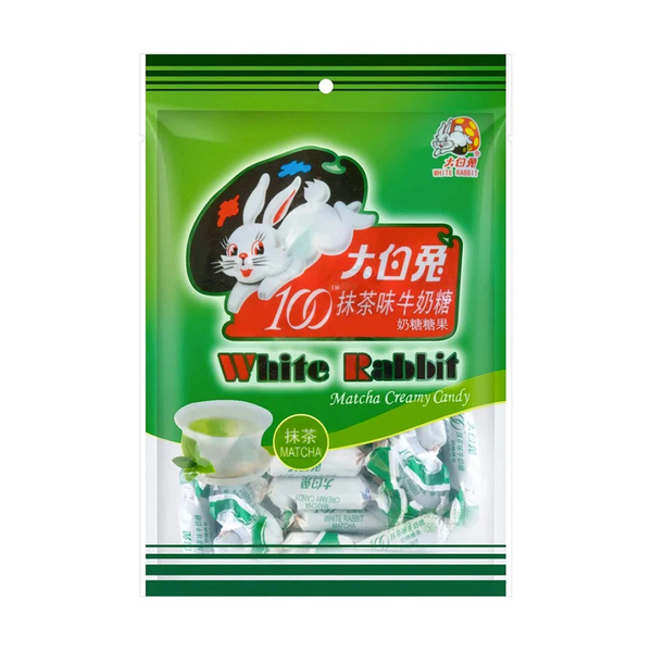 A package of White Rabbit 100 Matcha Creamy Crusty matcha-flavored candy, featuring a green and white design with a cartoon white rabbit wearing a black hat.
