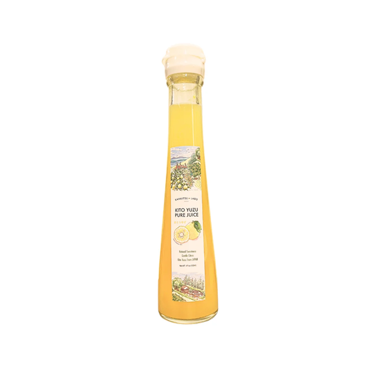 Bottle of yuzu pure juice on white background